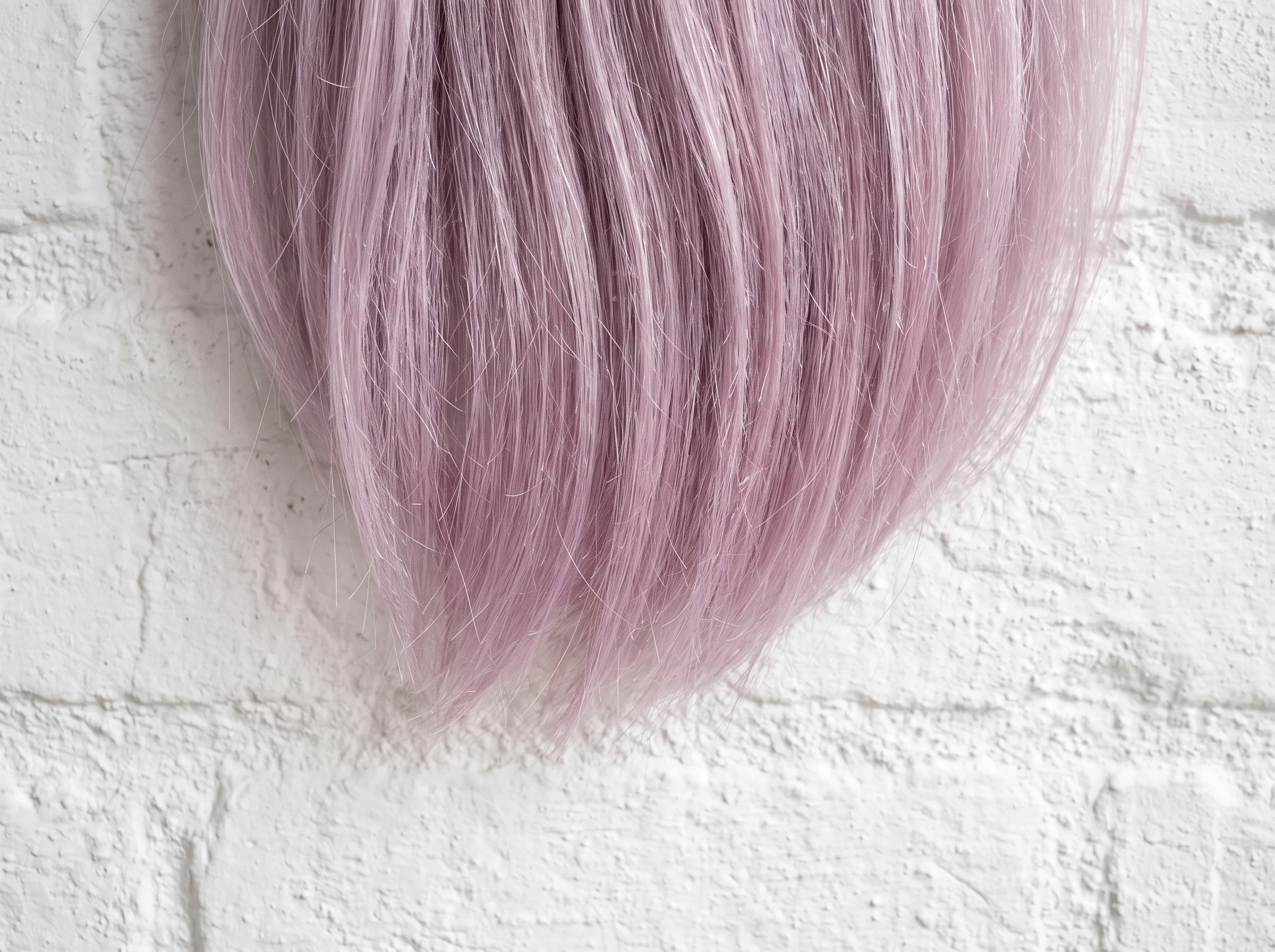 Pastel lilac hair photographed macro-close in flat daylight, tone even to the ends